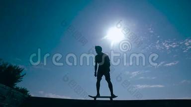 滑板运动员剪影滑板在天空背景日落。 慢动作。