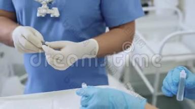 特写医生和护士双手戴无菌手套，用液体药剂填充注射器..