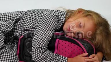 一个学生抱着书包睡觉