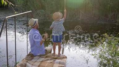 钓鱼，爸爸在<strong>小河边</strong>的家庭娱乐活动中教儿子钓鱼