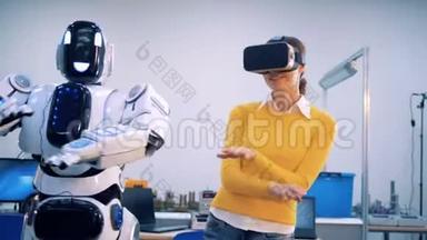 机器人和女人用手臂跳舞。