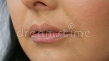 在美容院的特写镜头中，<strong>发型师</strong>用特殊的画笔描绘嘴唇