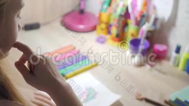 十几岁的女孩在家里从事创意，在房间的一张桌子上画水彩。 幼儿绘制俯视图.. 艺术作品