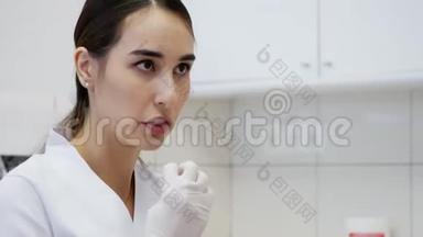 女<strong>牙医</strong>告诉病人如何刷牙。 去看<strong>牙医</strong>
