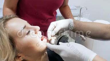 牙科医生在美白前检查病人<strong>牙齿</strong>`颜色的4k镜头
