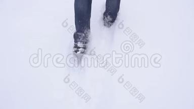 冬天穿靴子的人在冬天的大雪中行走，动作缓慢，<strong>天气晴朗</strong>