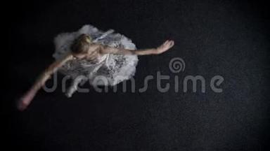 图图中年轻优雅的女芭蕾舞演员的剪影从一个角落旋转到另一个角落，芭蕾舞概念，顶级镜头