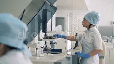 一名护士在<strong>验血</strong>机上工作。 屏幕上的医生类型，而特殊机器则开始在