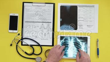 保健和医疗理念.. 数字平板电脑屏幕上的X射线图像。 医疗台面俯视图..