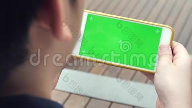 亚洲男孩在家沙发上看平板<strong>电脑显示</strong>器，人们使用带有绿色屏幕的数字平板电脑，