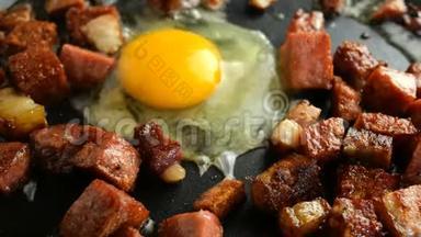 做美味的热菜。煎鸡蛋或煎蛋卷和肉丁，脆，腊肠和培根在热脂肪中炸