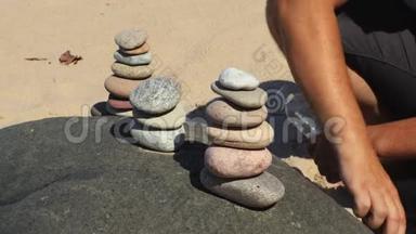 人建造平衡的石头金字塔.
