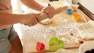 在木制台面上为馅饼准备擀面杖和擀面团的4k视频特写