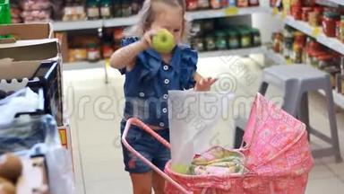 商店里的女孩子买东西。 母亲带着孩子买水果。