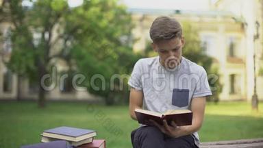 集中青少年在长凳上的公园看书，准备<strong>考试</strong>