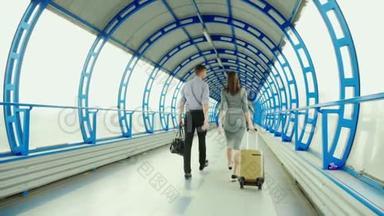 后景：商业伙伴-一男一女在车站或机场的终点站携带行李。 商务