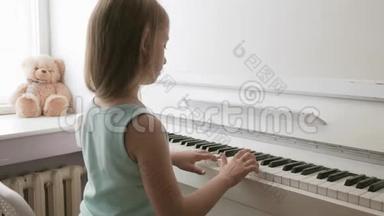 在家学习弹钢琴的小女孩.. 学龄前儿童玩音乐乐器