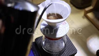 咖啡师用咖啡将水倒入过滤器，冲泡咖啡