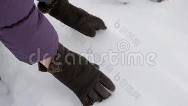 双手合拢，戴上温暖的冬天手套，拿起一把新鲜的蓬松的雪