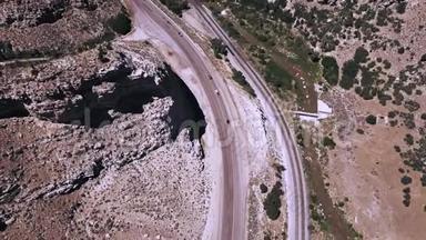 俯视空中拍摄美丽的公路公路和铁路轨道之间惊人的岩石砂岩山脉。