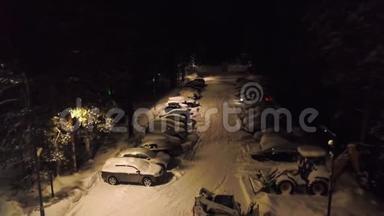 森林里白雪覆盖的停车场。 剪辑。 顶部的停车景观，有覆盖积雪的汽车和站立的推土机来清扫积雪