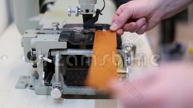 操作人员正在调整自动皮革滑脱机在一家服装厂。 分割、对齐和切割