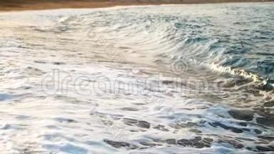 拍摄日落时海浪拍打海岸后海水旋转和沸腾的慢动作视频