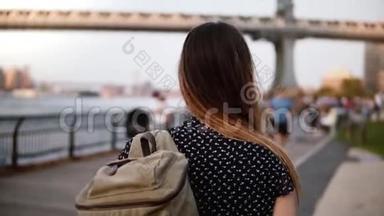 镜头跟随年轻的女游客，带着墨镜的背包沿着阳光明媚的纽约布鲁克林公园慢走