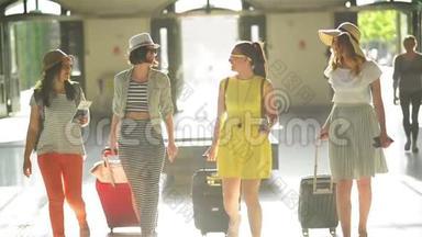 四个漂亮漂亮的女孩在机场手中拿着文件、<strong>门</strong>票和大<strong>型</strong>手提箱。 正面视<strong>图</strong>