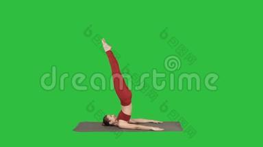 美丽的运动女孩做瑜伽锻炼腹肌力量，支持肩倒立阿萨纳，萨兰巴萨万加萨纳在一个