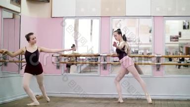 在舞厅里，穿着黑色紧身衣的年轻芭蕾舞女演员正在伸展芭蕾舞，站在芭蕾舞剧的镜子旁