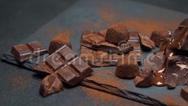 深色或牛奶巧克力片、巧克力糖浆和深色混凝土背景的松露糖果