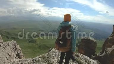 一个带着双肩包和太阳镜的微笑的旅游女孩带着她的相机走在一个岩石高原的边缘