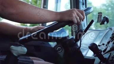 无法辨认的人手握方向盘，在温暖的夏日在乡间道路上驾驶汽车。 卡车司机