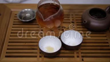 人把茶从柴海倒入碗里。 中国茶道仪式