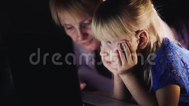 母女俩躺在床上，用笔记本电脑.. 面对面，<strong>一切</strong>都是一起做的概念