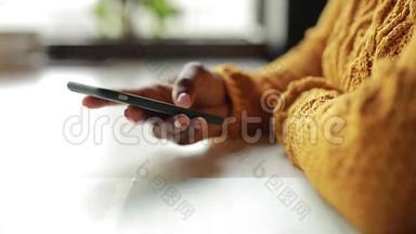 在咖啡馆里用智能手机的非洲女人