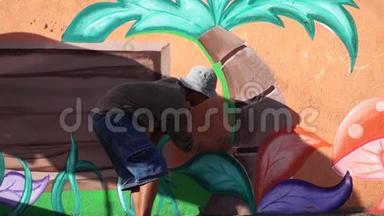 <strong>墙画</strong>家在混凝土墙上画一棵椰子树。