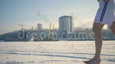 一个光着脚在冰冻的河流上奔跑的人。