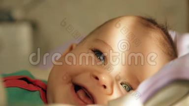 一个快乐的婴儿躺在摇篮和微笑的特写镜头的肖像。
