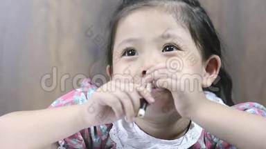 合拢可爱的小亚洲女孩快乐的微笑和铅笔在手