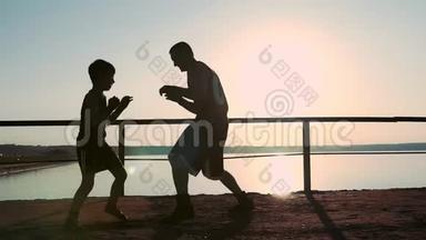 强壮的年轻<strong>高个子</strong>男拳击手教他的小儿子如何正确的拳击