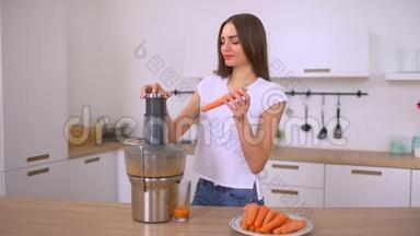 用榨汁机做胡萝卜汁的女人。 用胡萝卜做新<strong>鲜果</strong>汁。 女孩用胡萝卜准备新<strong>鲜果</strong>汁。