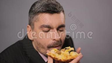 饥肠辘辘的上班族吃着开胃的奶酪披萨，男人享受快餐
