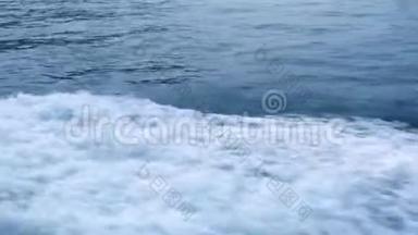 蓝色海面上的水迹从漂浮的船靠近。 带着泡沫和波浪的绿松石<strong>海水</strong>