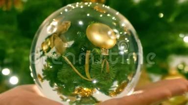 用手中的玻璃球看到装饰好的圣诞树