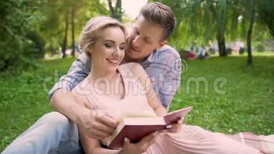 情侣一<strong>起坐</strong>在地毯上看书，在休息时轻轻亲吻