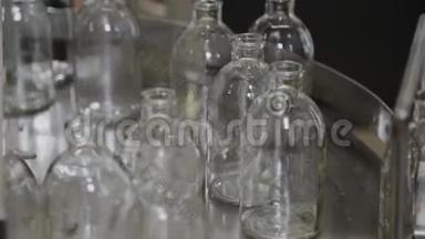 玻璃无菌药瓶在传送带上，用于填充内容物。