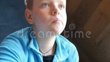 蓝眼睛的帅哥少年在快餐店吃薯条，抬头看了看