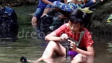 菲律宾农村社区缺乏公共供水系统的公用设施，迫使这个男孩即使在污染的里也要洗澡和洗澡